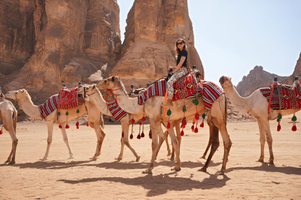A female tourist riding a camel in Saudi Arabia.
